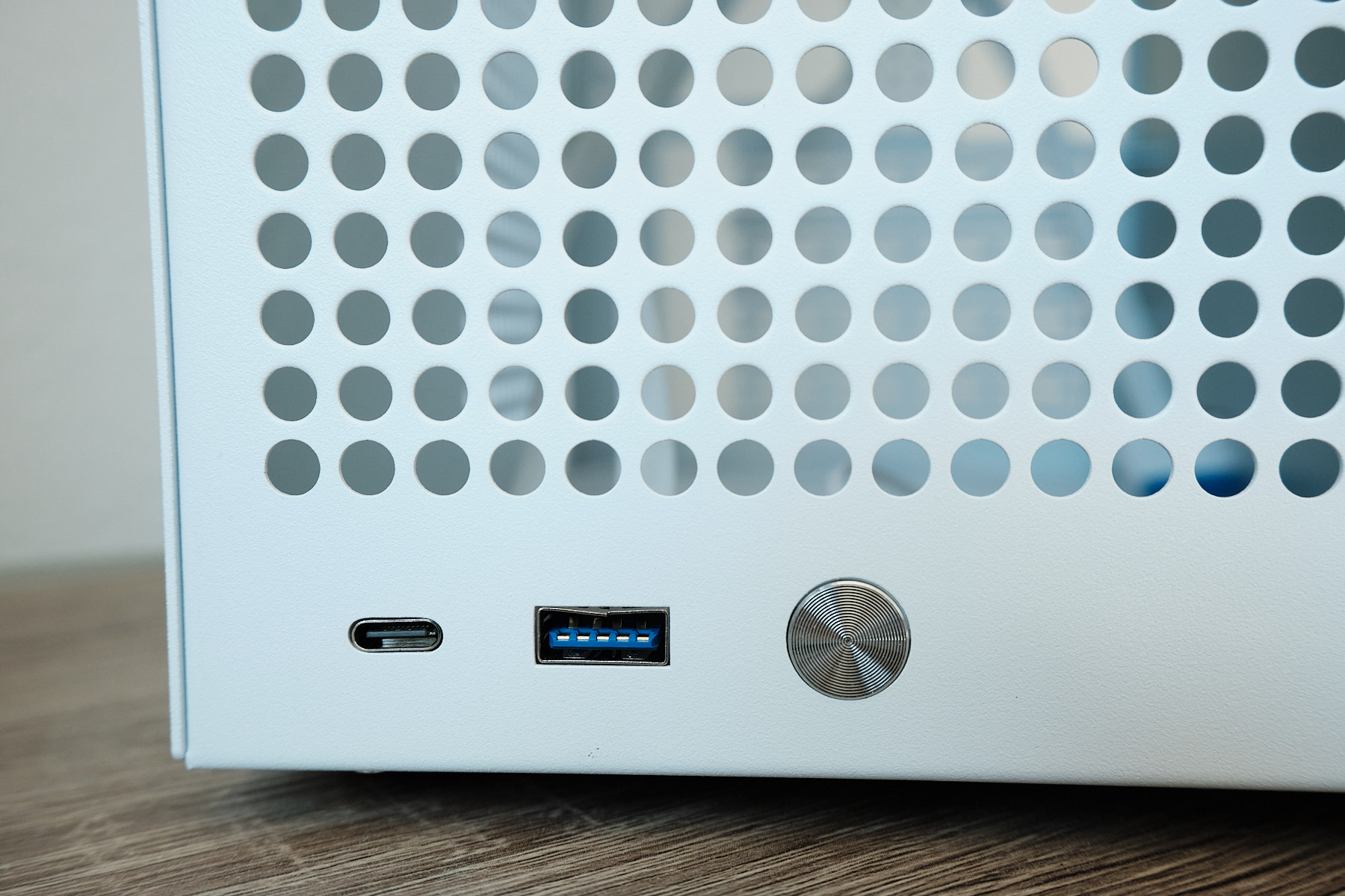 Close-up of the front I/O on the Sagittarius NAS case showing the USB-C port, USB-A 3.0 port with blue connector, and circular power button