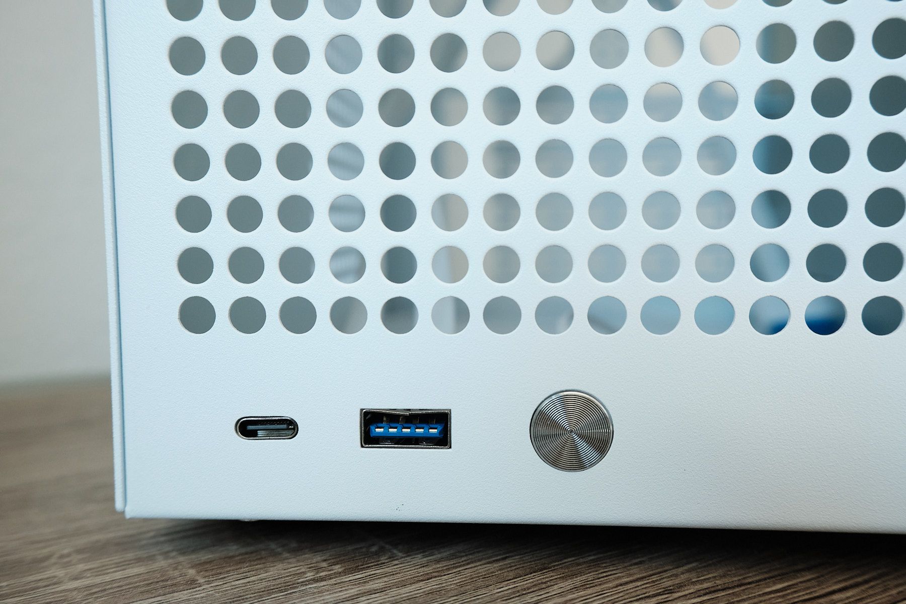 Close-up of the front I/O on the Sagittarius NAS case showing the USB-C port, USB-A 3.0 port with blue connector, and circular power button